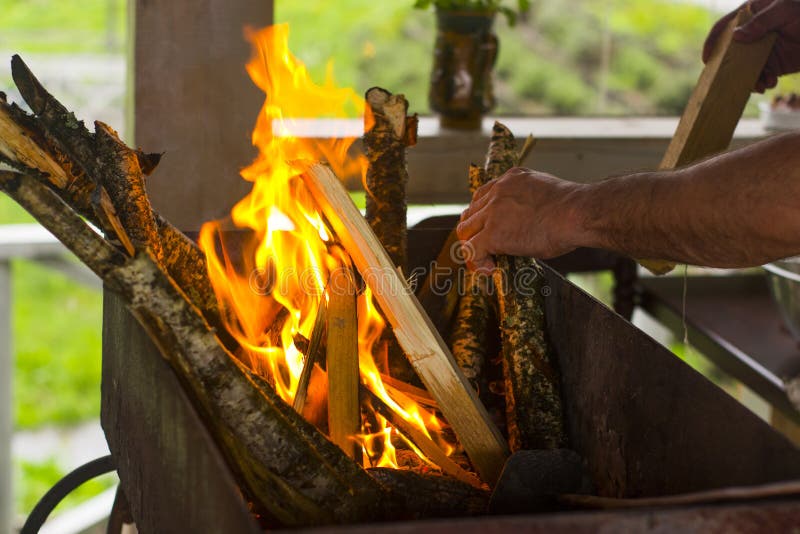 A Man Throws a Tree into the Fire Stock Photo Image of branches