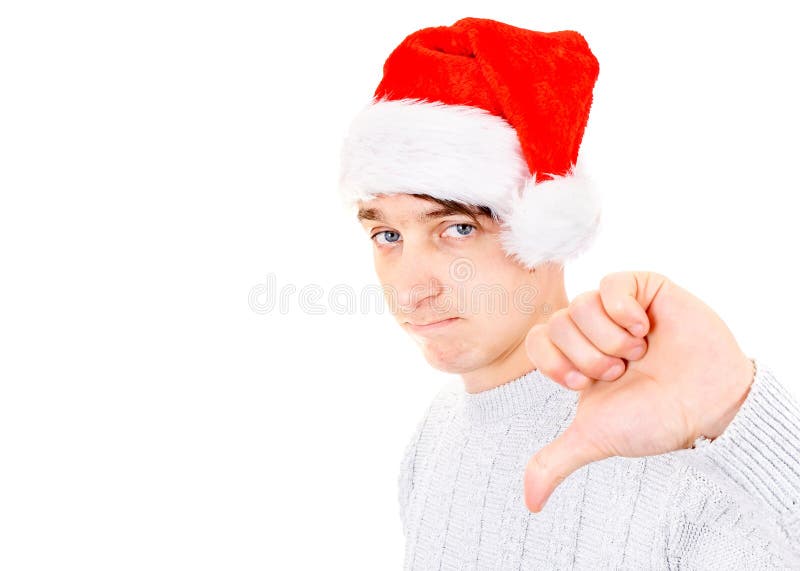 Sad Young Man in Santa Hat make Thumb Down on the White Background. Sad Young Man in Santa Hat make Thumb Down on the White Background