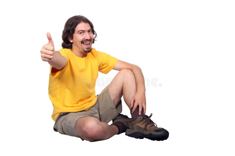 Smiling young man in casual clothes and shorts gesturing with thumb up, isolated on white background. Top smiling cheerful stock images, royalty-free photos and pictures