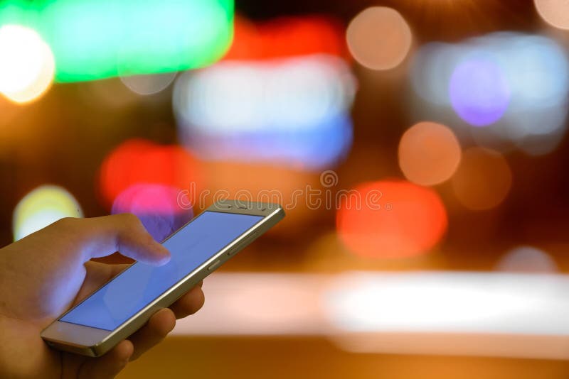 Man Touch Screen Mobile Phone, Night Light Bokeh Background Stock Photo
