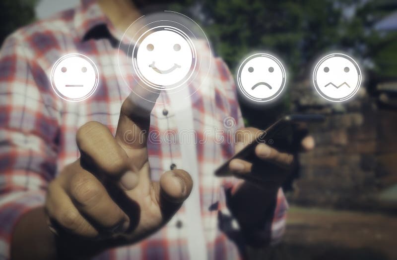 A man touching check mark icon and face emoticon smile on dark background stock photography