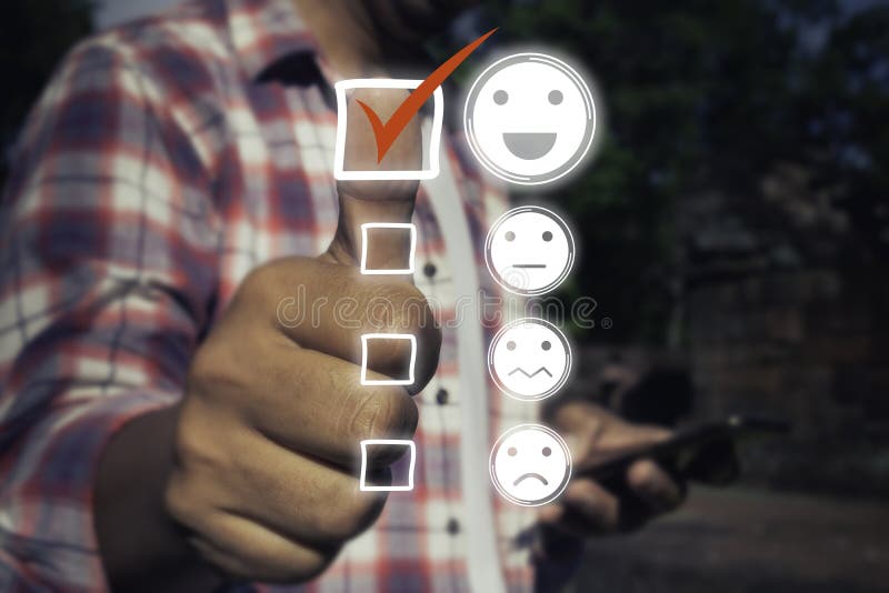 A man touching check mark icon and face emoticon smile on dark background. Customer service, service mind,service rating stock photos