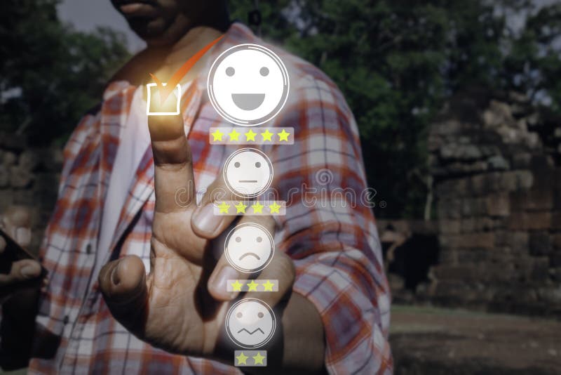 A man touching check mark icon and face emoticon smile on dark background. Customer service, service mind royalty free stock photo