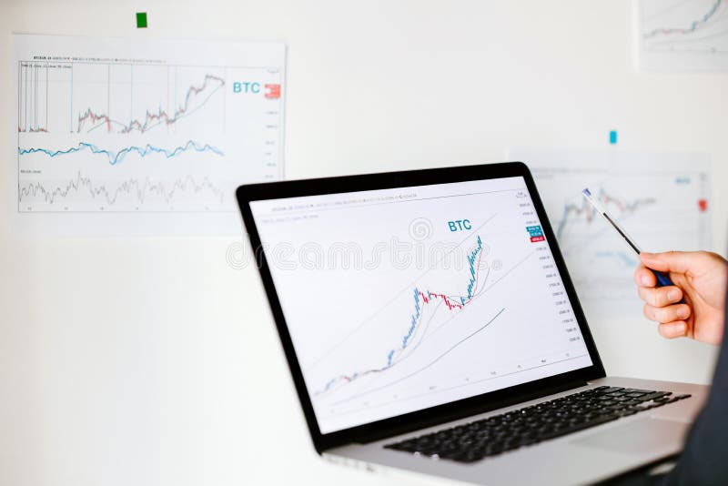 Man trader bitcoin data price trend analysing. Investment broker trading bitcoin crypto currency using phone and laptop.