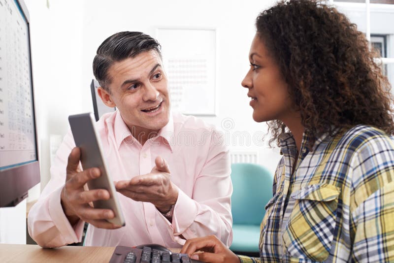 Man Training Woman In Office Using Digital Tablet stock photography Man Training Woman In Office Using Digital Tablet stock photography