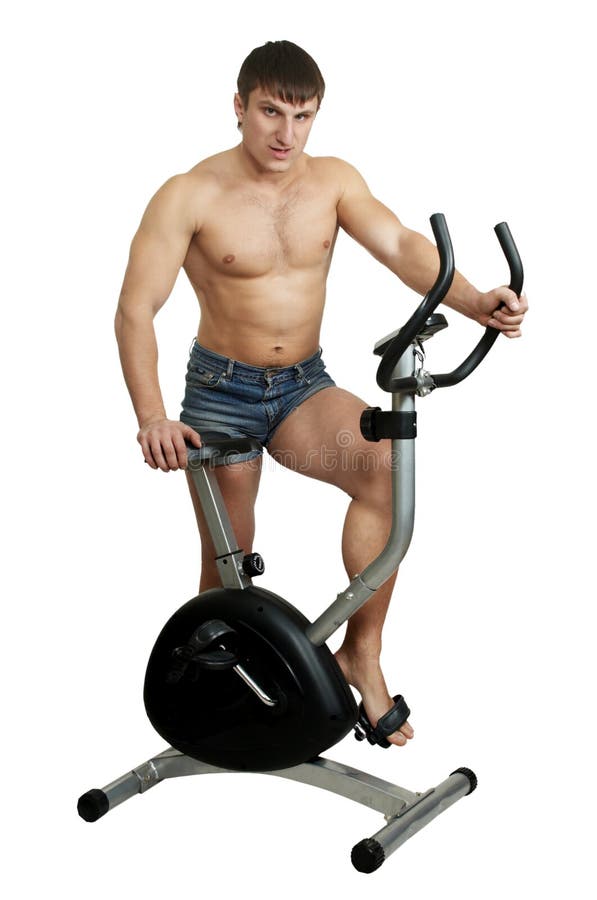 Man trains on exercise bicycle