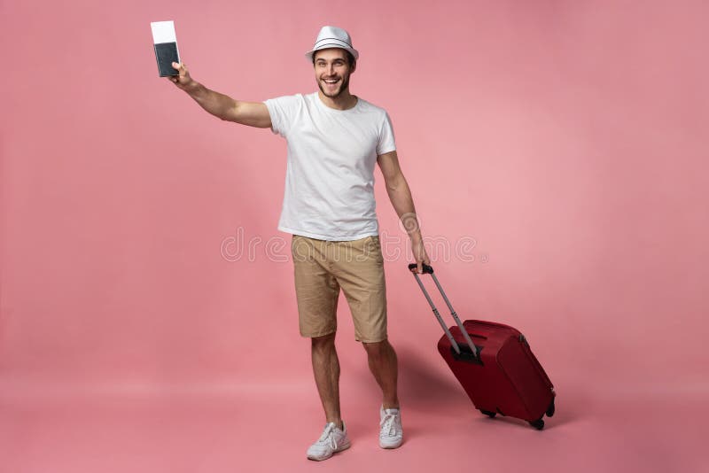 Man traveler with suitcase, passport and ticket on color background.