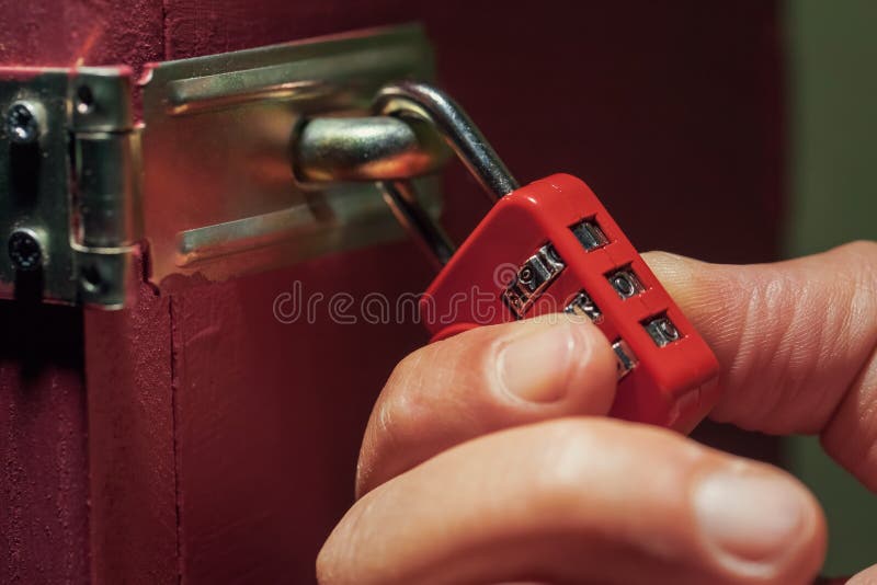 Man trying to unlock combination lock