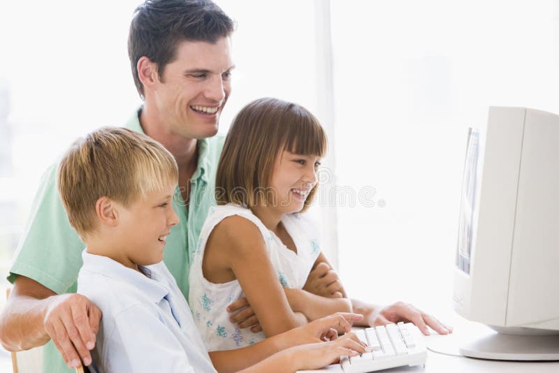 Man and two young children in home office with computer. Man and two young children in home office with computer