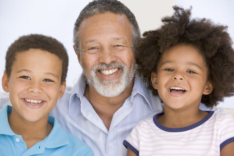 Close up of man and two young children smiling