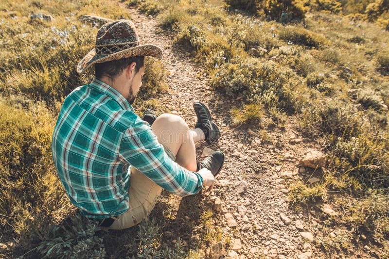 Man tying his boots on the mountain