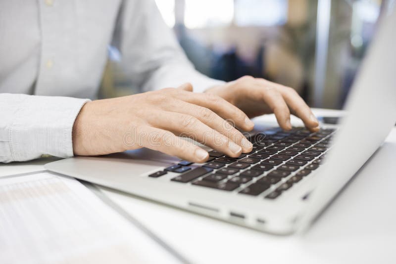 Man Typing on a keyboard laptop in an office, e-mail, message stock photography