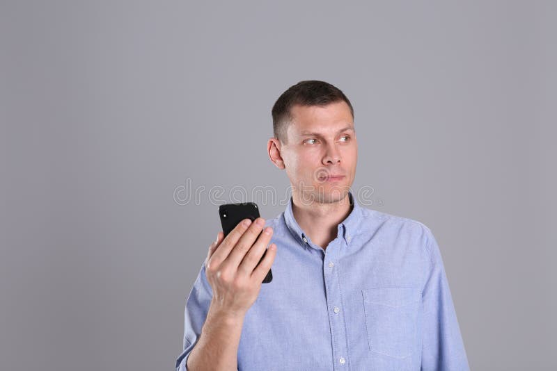 Man unlocking smartphone with facial scanner on background. Biometric verification