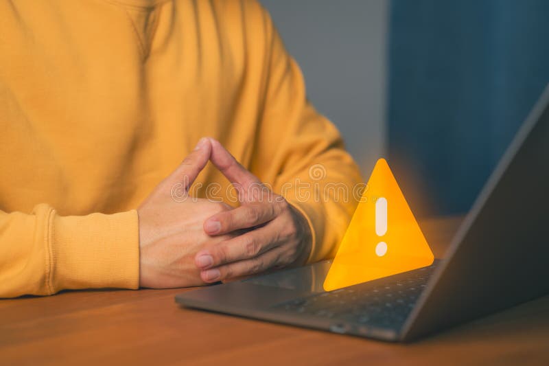Man use a laptop with caution warning sign for notification error. Cybersecurity technology concept of computer virus detect, personal data protection, network security and maintenance. Laptop personal computer stock images, royalty-free photos and pictures