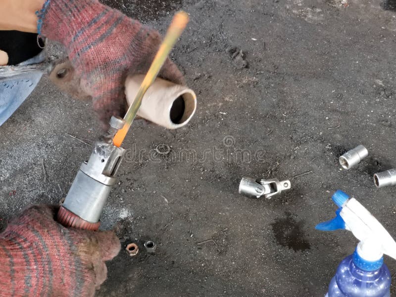 Man Using Air Gun Saw To Cut Metal Pipe. Stock Photo Image of power