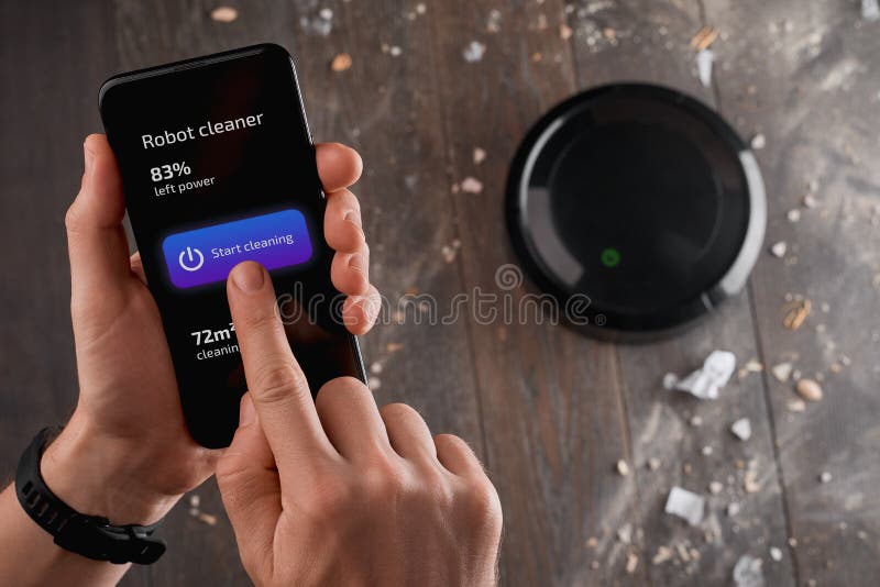 Man Using an App on His Phone To Turn on a Robotic Vacuum Stock Image Image of indoor