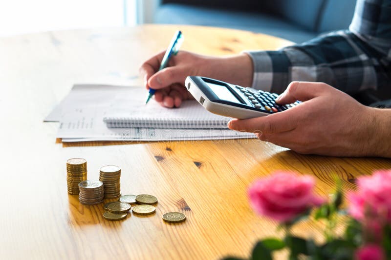 Man using calculator and counting budget, expenses and savings.