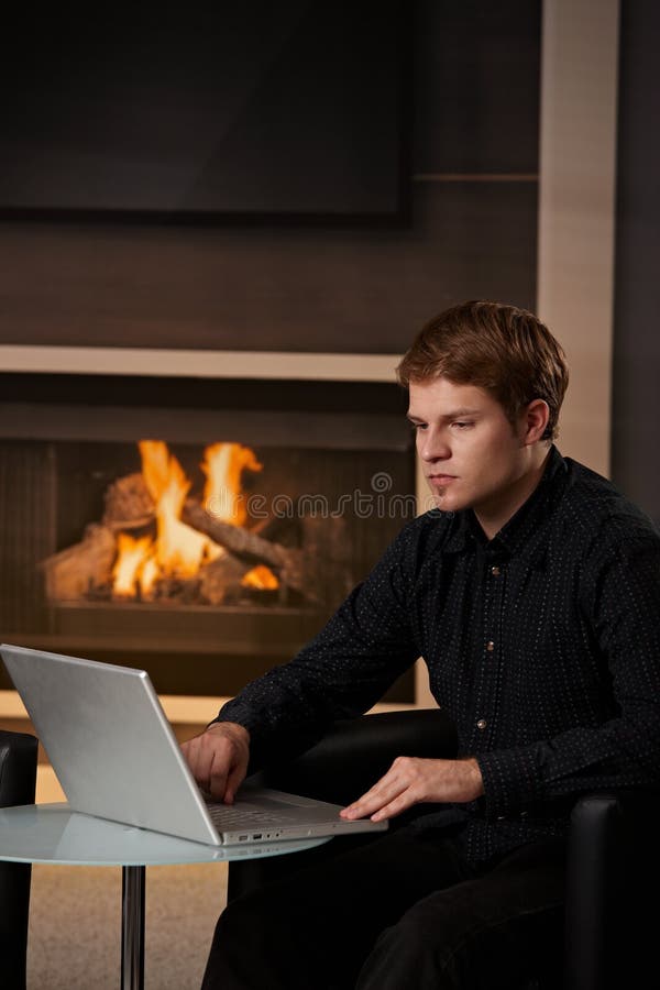 Man using computer at home royalty free stock photography Man using computer at home royalty free stock photography