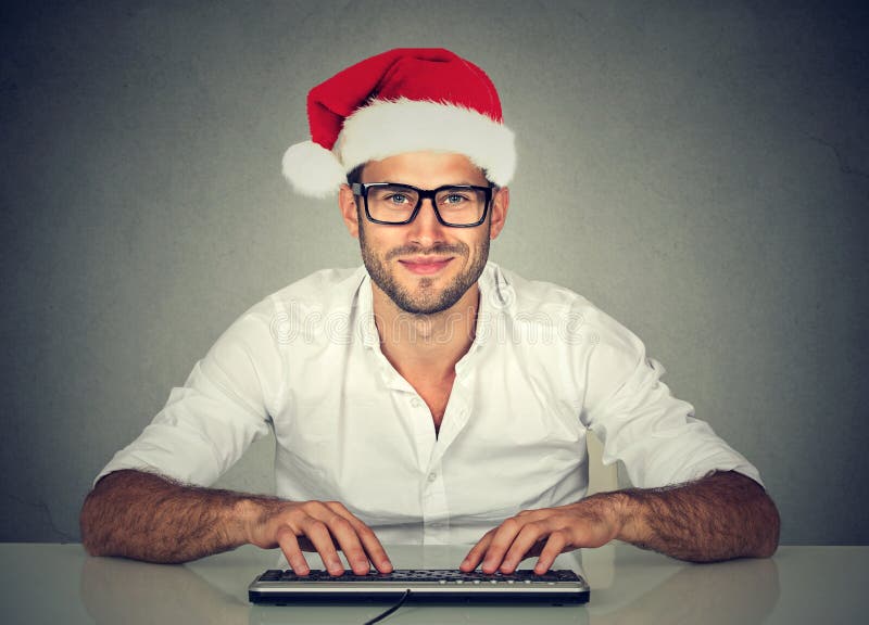Man using computer shopping online looking for a christmas gift. royalty free stock photo Man using computer shopping online looking for a christmas gift. royalty free stock photo
