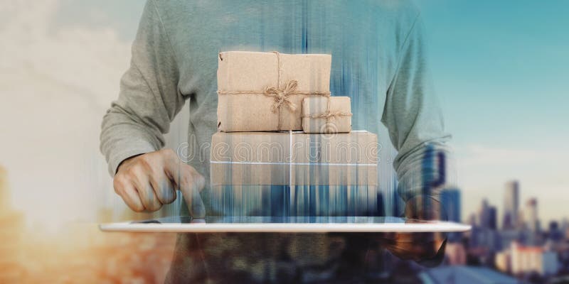 A man using digital tablet with parcel post boxes on screen. Online shopping, e-commerce and delivery concept stock photos