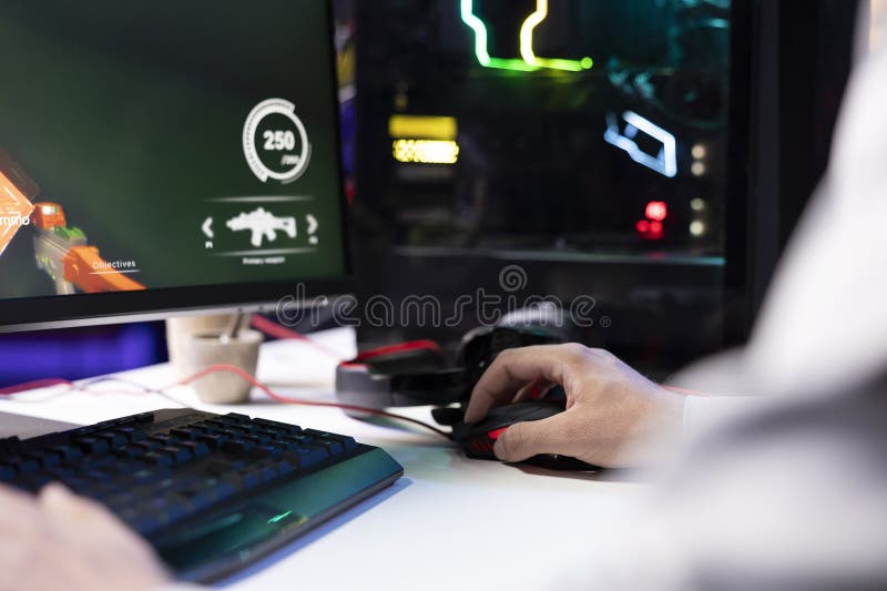 Man using gaming mouse to enjoying coop FPS videogame royalty free stock image