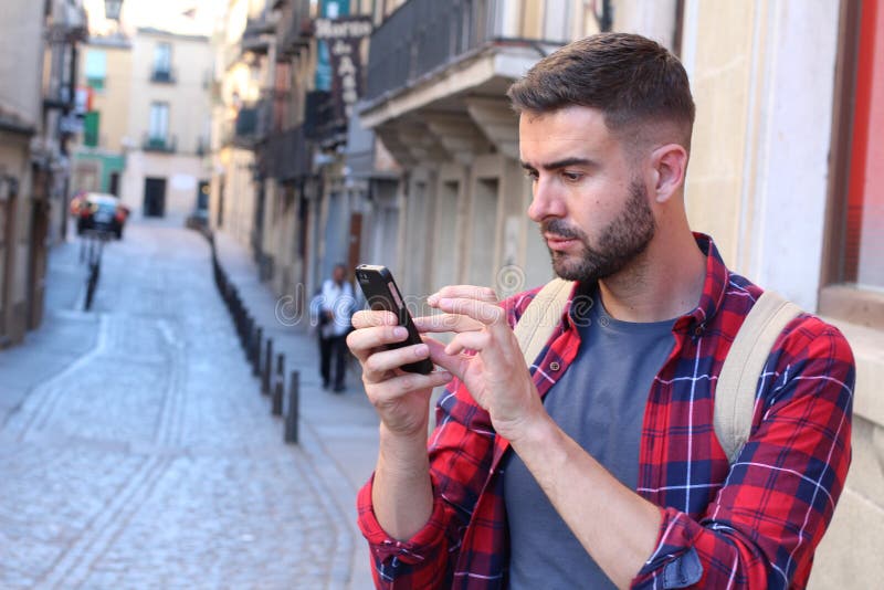 Man using GPS on his cell phone to find the right way.