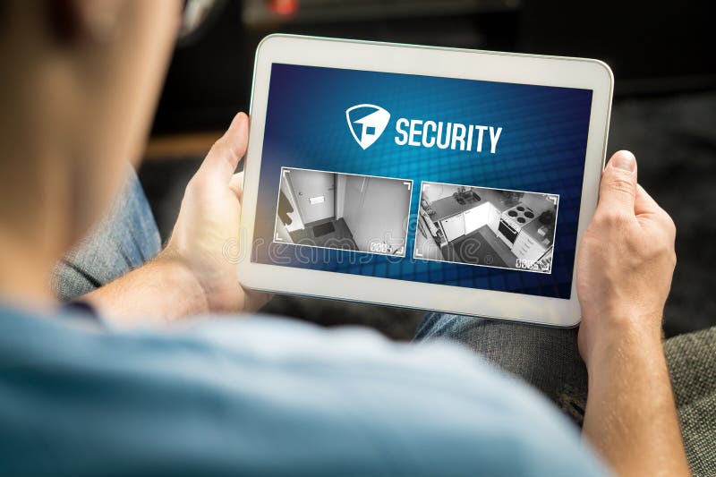 Man using home security system and application in tablet. royalty free stock photo