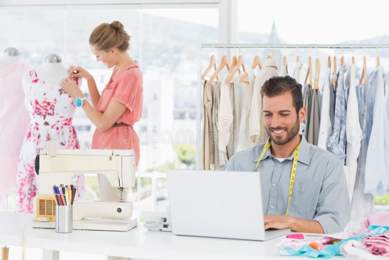 Man Using Laptop with Fashion Designer Working at Studio Stock Image ...