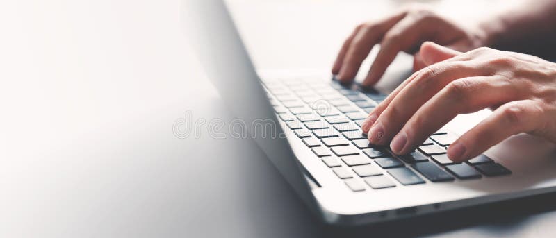 Man using laptop at home, typing hands royalty free stock photo