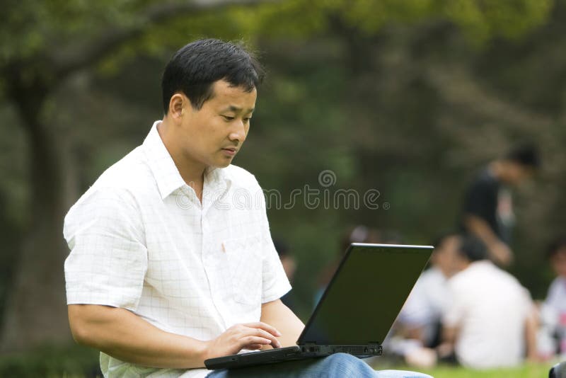 Man using a laptop outdoors