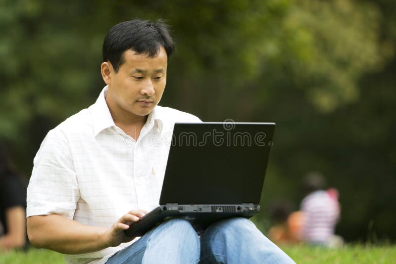 Man using a laptop outdoors