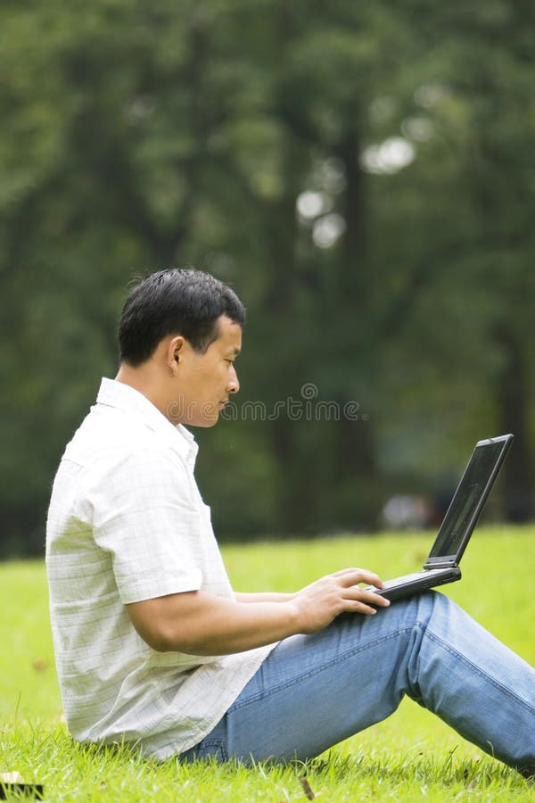 Man using a laptop outdoors