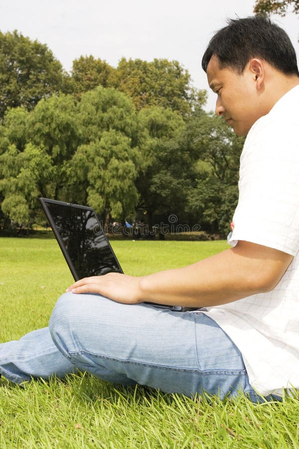 Man using a laptop outdoors