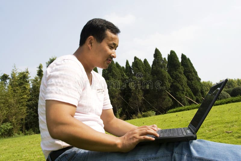 Man using a laptop outdoors