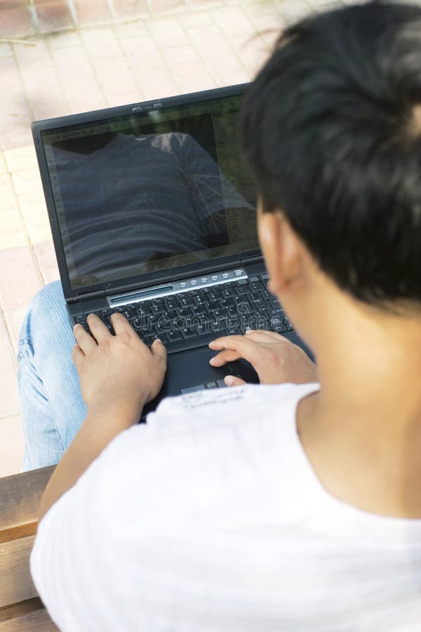 Man using a laptop in the park