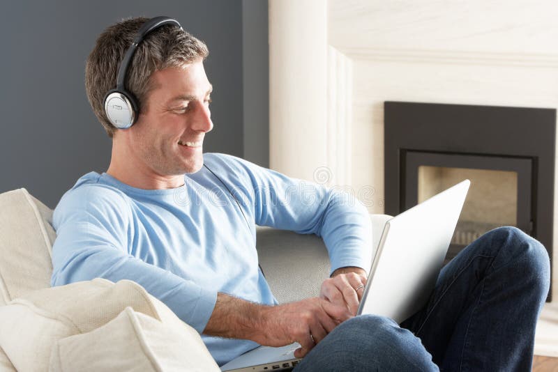 Man Using Laptop Wearing Headphones Relaxing
