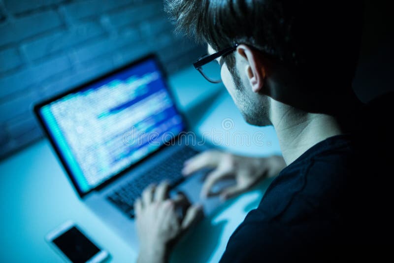 Man using laptop writing programming code on laptop. Young hacker work on laptop in the night. Source code script stock images, royalty-free photos and pictures
