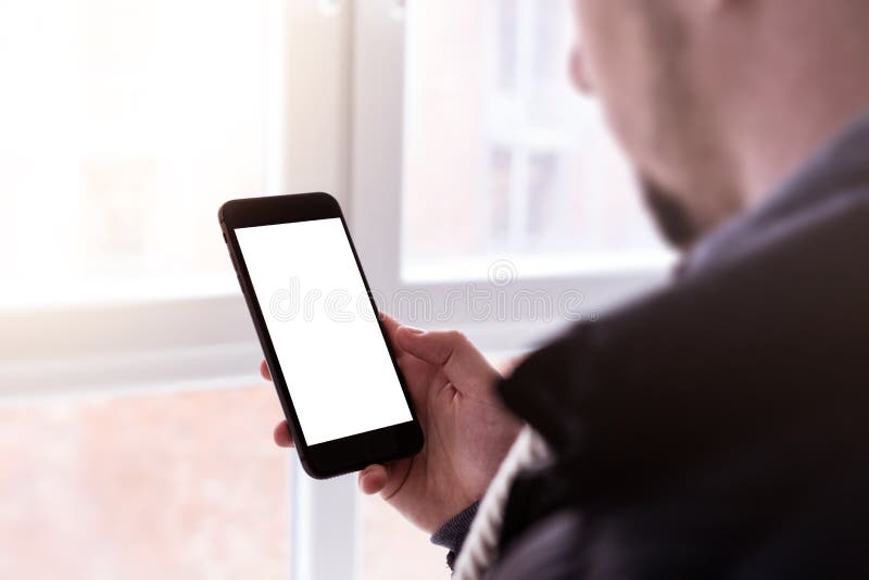 Man using modern mobile smartphone. Shot with third-person view, blank screen. stock photography Man using modern mobile smartphone. Shot with third-person view, blank screen. stock photography