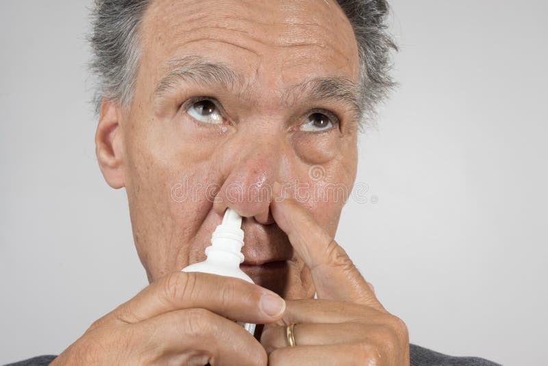 Man Using a Nasal Spray for His Nose Stock Photo Image of irritation