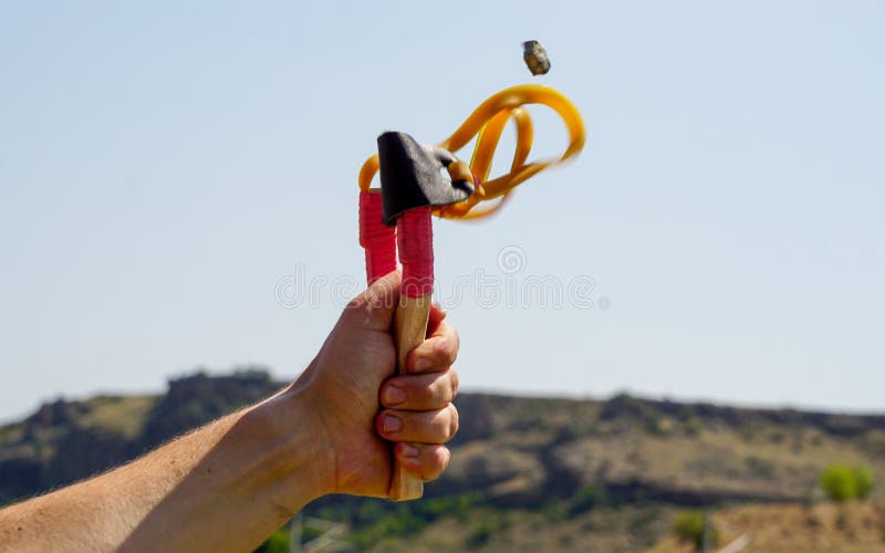 Man Using Spear Thrower Throwing Rock Nature Amusement Stock Image