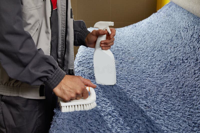 Man Using Spray To Remove Stain From Carpet In Carpet Cleaning Service Stock Image Image of