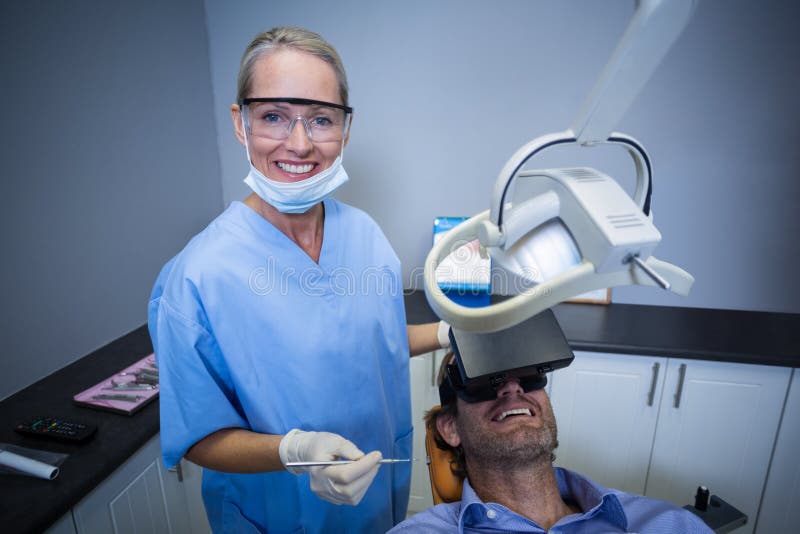 Man Using Virtual Reality Headset during a Dental Visit Stock Photo