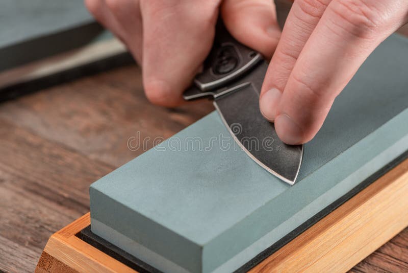 Man Using a Whetstone To Sharp His Pocket Knife Stock Image - Image of  instrument, dull: 186242253