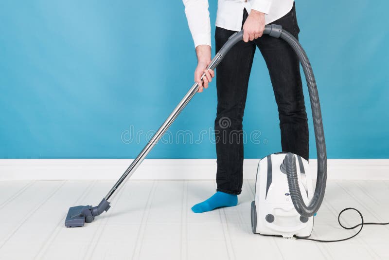 Man with vacuum cleaner stock image. Image of working 48579577