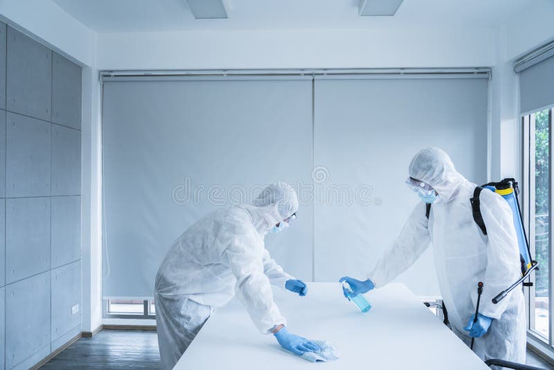 Man in virus protective suite and mask cleaning covid19 infected area, Virus disinfection concept