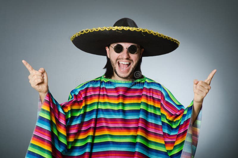 The man in a vivid mexican poncho gray background isolated