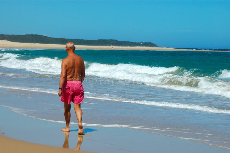 Man walking on beach royalty free stock photography
