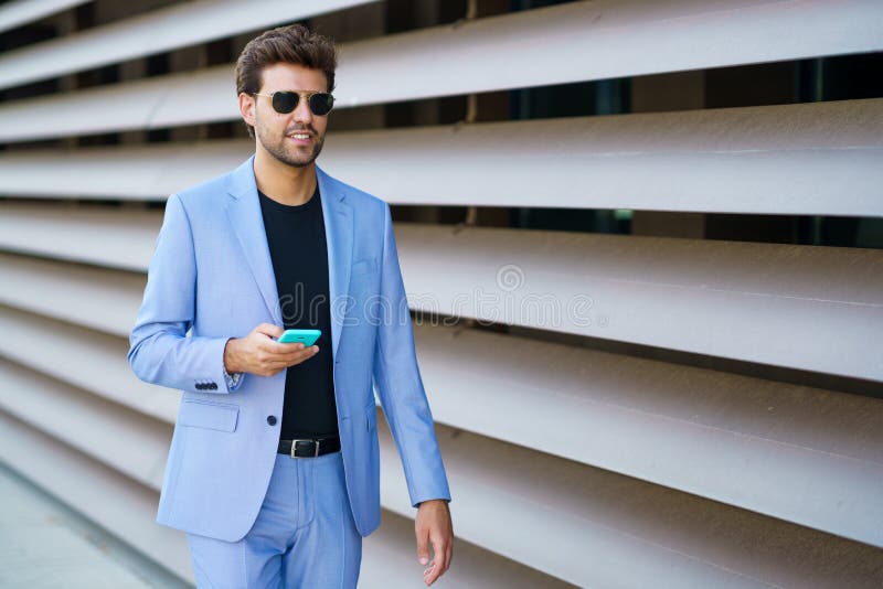 Man walking down the street using his smartphone