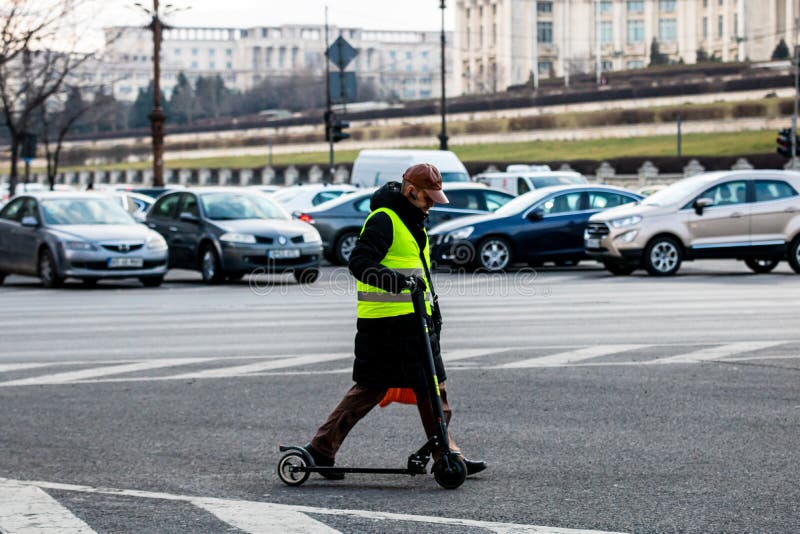 Man Walking Next To a Electric Scooter in Bucharest, Romania, 2022
