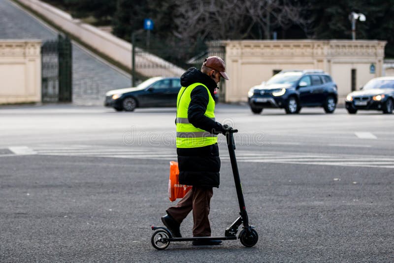 Man Walking Next To a Electric Scooter in Bucharest, Romania, 2022